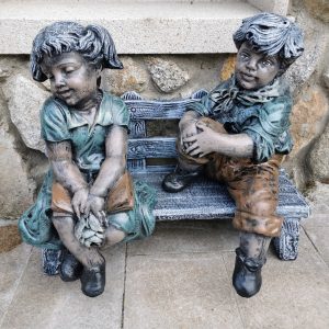 Boy and Shy Girl Sitting on Bench